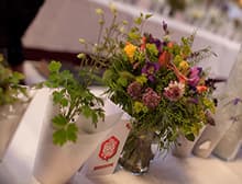 A posy of wildflowers in a glass vase on a table